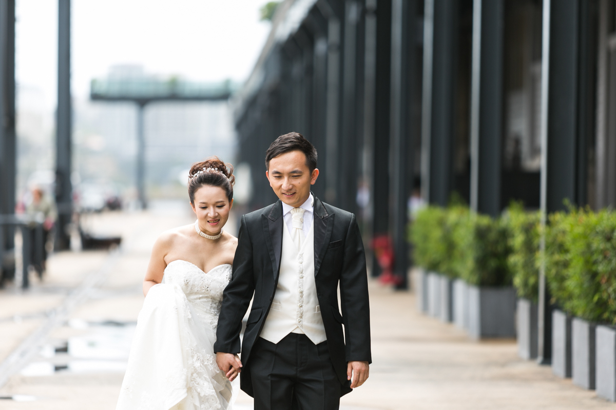 Candid shot of the bride and groom walking hand in hand at The Rocks in Sydney wedding photographer