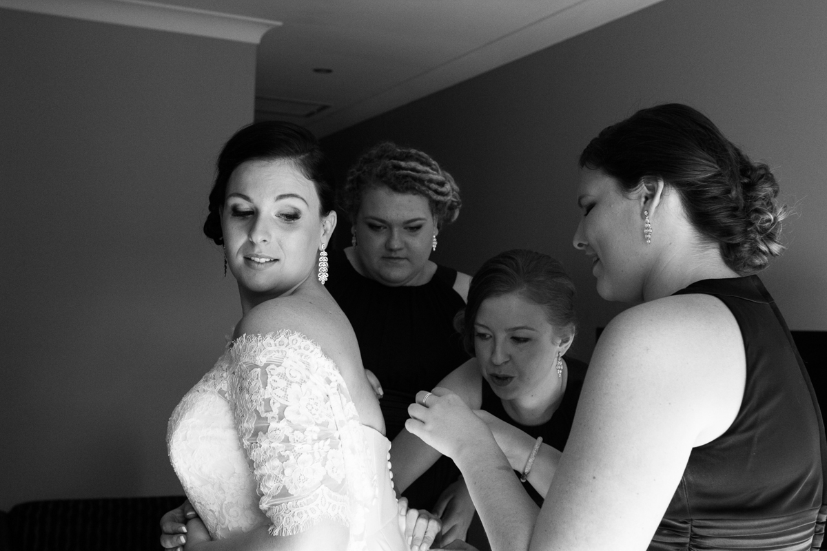 07_bride getting ready with bridesmaids at crowne plaza with wedding reportage