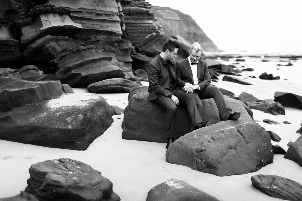 11_Gay couple share sweet moment at Susan Gilmore beach captured by newcastle wedding photographer