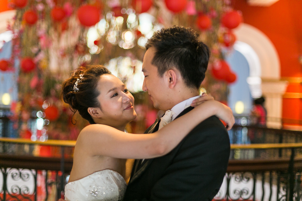 The bride and groom look into each other's eyes against the backdrop of bright red hanging lanterns Sydney wedding photographer