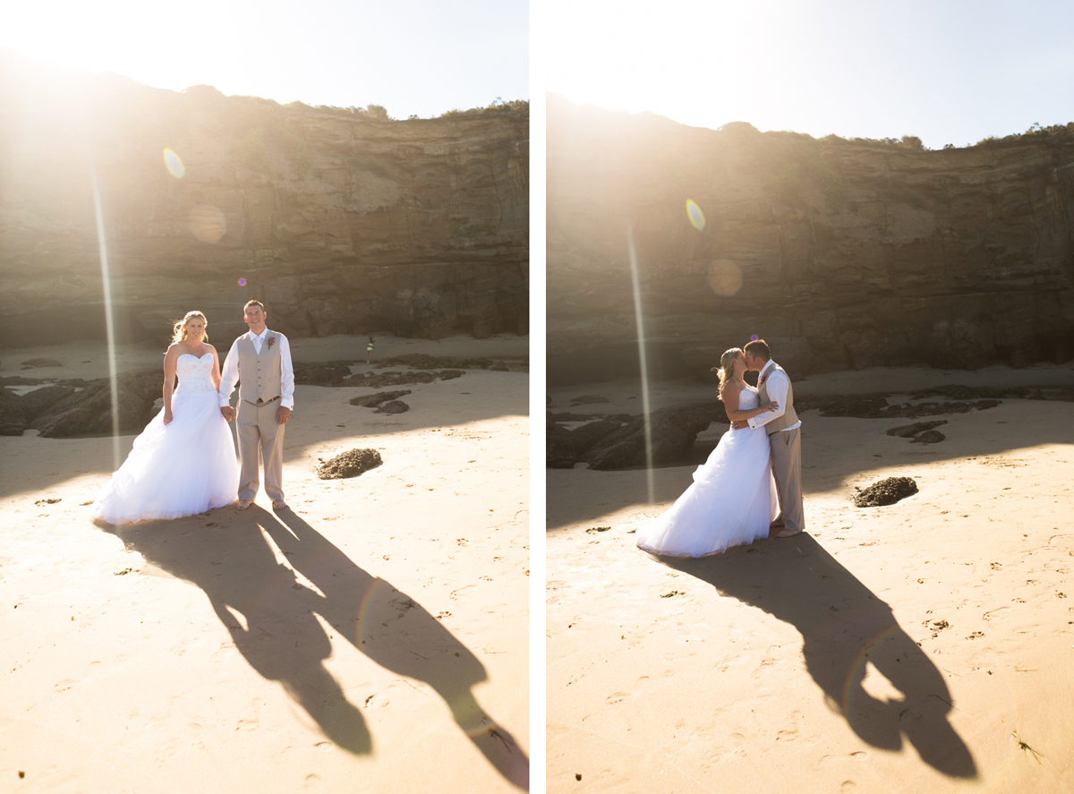 Dual shot of the bride and groom standing on the beach in front of caves and cliff faces with sun streaming in behind them Caves Beach wedding photography