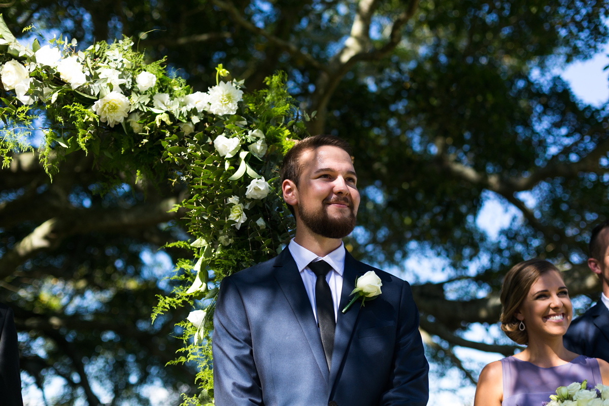 Reaction shot of the groom seeing the bride walking down the aisle for the first time Tocal Homestead wedding photographer